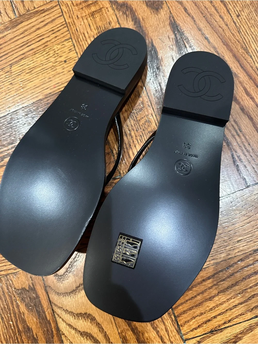 CHANEL Black Leather Logo Thong Sandals with Gold Accent